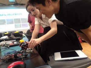Kat demonstrating motor disassembly to a student